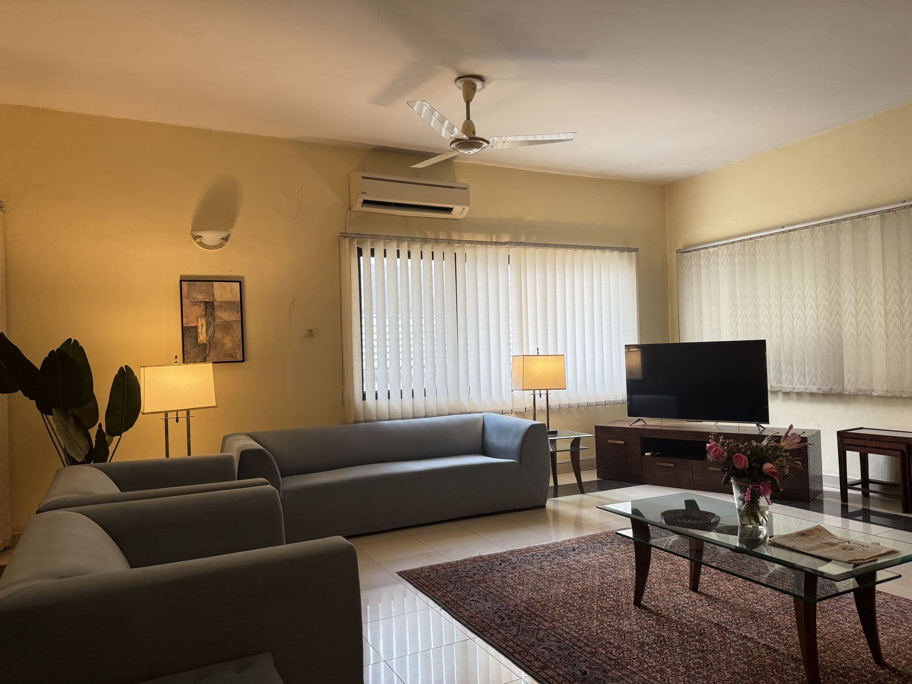 The waiting lounge at Western Dental Practice, with sofas, lamps and a television.